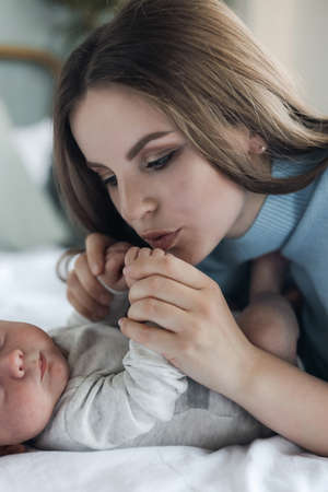 happy mother with little cute newborn at home