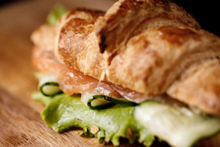 closeup croissant with salmon and cucumberの写真素材