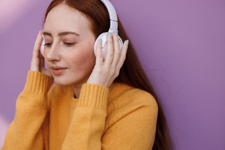cute woman with headphones outdoorの写真素材