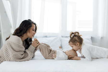 mother and lovely baby and daughter indoor at home