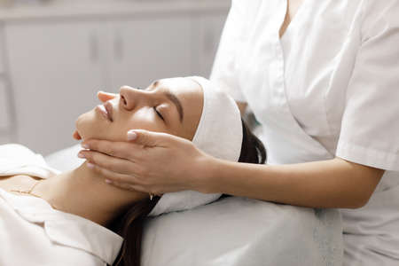 Doctor doing face massage and mask for skinの写真素材