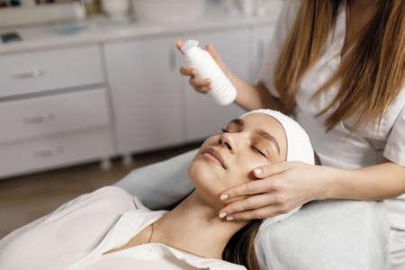 cosmetological procedure for pretty female mask and massageの写真素材