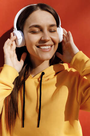 young smiling woman listen to the music in headphones
