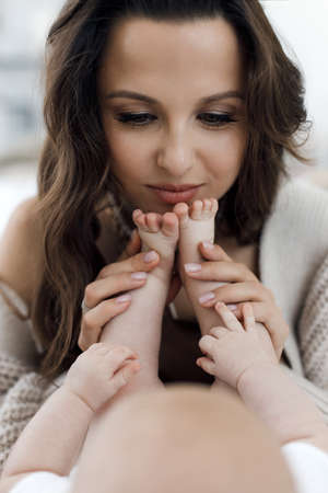 mother and lovely baby and daughter indoor at homeの写真素材