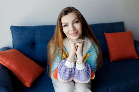 pretty smiling woman indoor in cozy wear