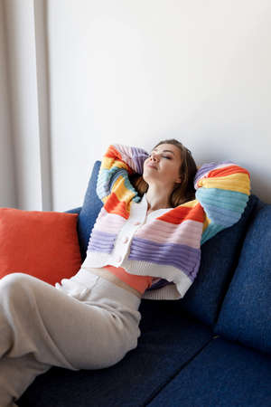 pretty woman in cozy wear chill at home smilingの写真素材