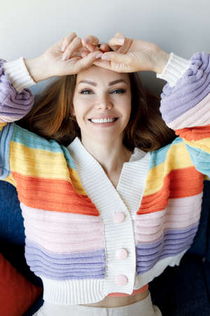 pretty smiling woman indoor in cozy wearの写真素材