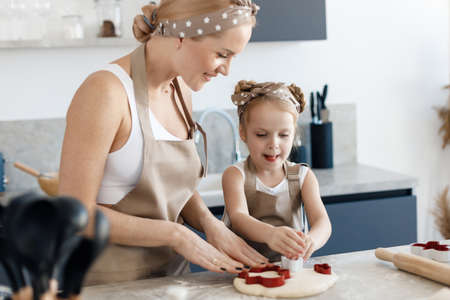happy kid and mother baking and cooking at homeの写真素材