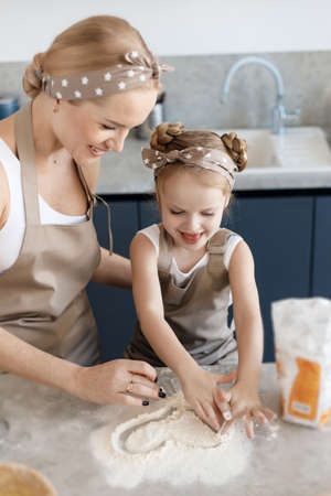 mother and daughter cooking and baking in the kitchenの写真素材