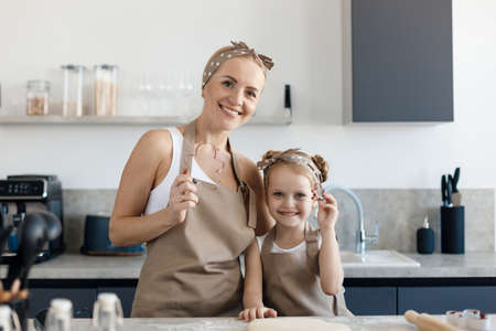 mother and daughter cooking and baking in the kitchenの写真素材