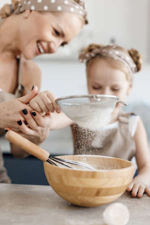 mother and daughter cooking and baking in the kitchen