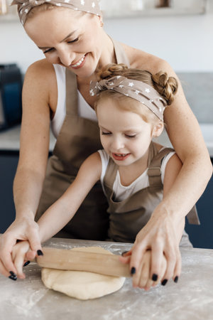 mother and daughter cooking and baking in the kitchenの写真素材