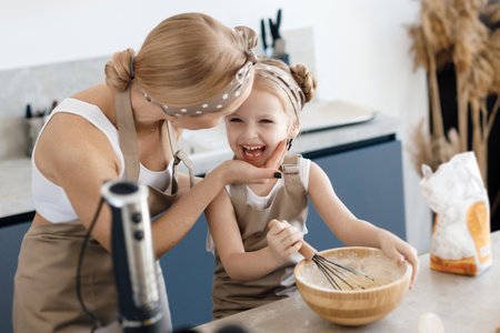 mother and daughter cooking and baking in the kitchen