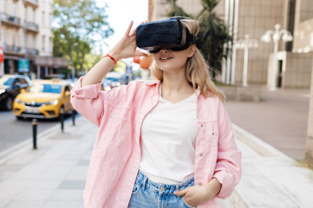 Young woman in VR glasses outdoorsの写真素材