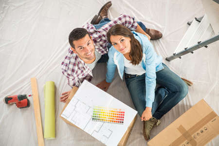 couple in new home choosing wall paint colorsの写真素材