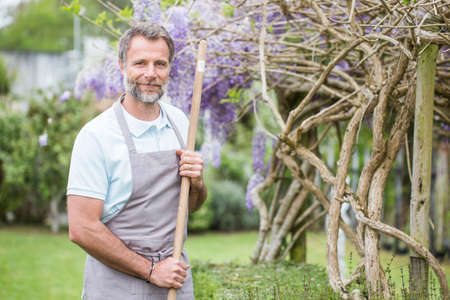 Attractive senior man working in a gardenの写真素材