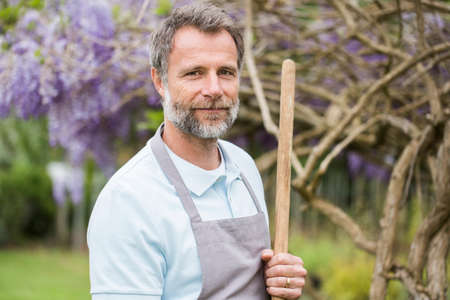 Attractive senior man working in a garden