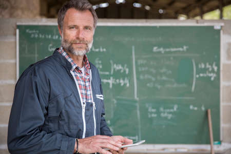 farmer using a digital tablet in a barn