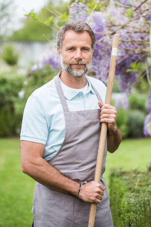 Attractive senior man working in a garden