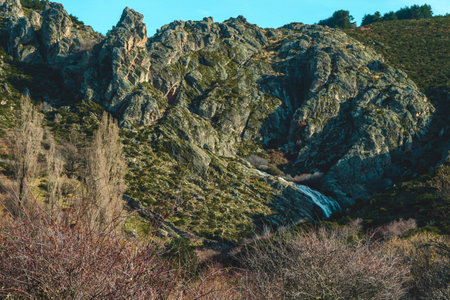 Mountain landscape with a waterfall of a river and a forest.の写真素材