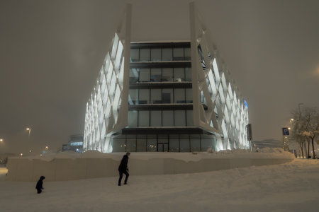 Snow in the city. Woman and child walking in the snow at dusk. Taken in Madrid during the storm. Madrid, Spain; 01 09 2021のeditorial素材