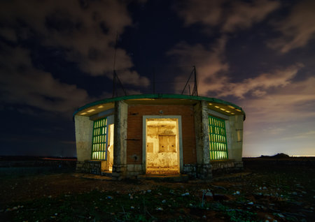 Abandoned building at night illuminated moodyの写真素材