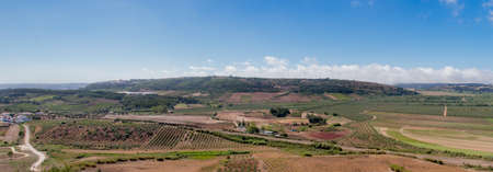 Panorama of a countryside view with farms and a blue skyの写真素材