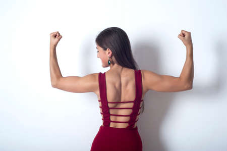 girl showing muscles in her armsの写真素材