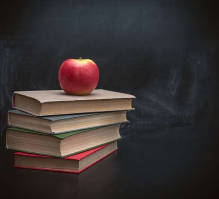 Red apple on a pile of booksの写真素材