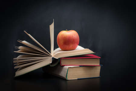 Red apple on a pile of booksの写真素材