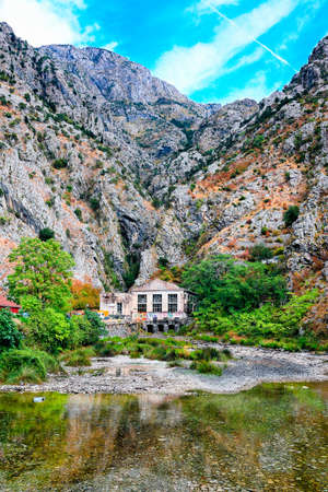 Mediterranean landscape. Overhanging cliffs, old power station and river.の写真素材