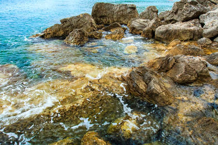 Sea surface, rocks on the shore. Natural background.の写真素材