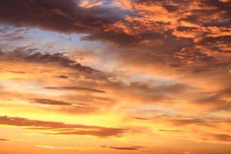 Colorful sunset sky, fiery orange clouds. Natural background.