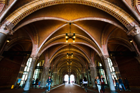 AMSTERDAM, NETHERLANDS - AUGUST 03, 2017: The pedestrian and bicycle tunnel through the Rijksmuseum. People, cycle path under the dutch national museum. View of the main entrance and arch.のeditorial素材