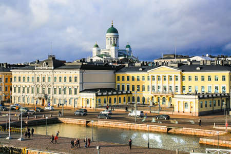 Panorama of Helsinki, Finland. Aerial view of downtown city. Famous Lutheran Helsinki Cathedral (Tuomiokirkko), Old Town, Harbor (Etelasatama) and Market square in evening light, cloudy sky, horizon, autumn skyline.の写真素材