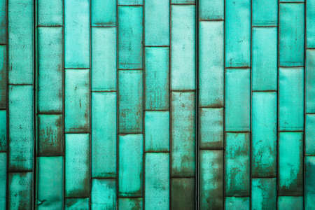 The copper-green sheathing of the building. Old grunge metal tiles wall. Brushed rustic plates. Detail of the structure of building. Rusty dirty surface.の写真素材