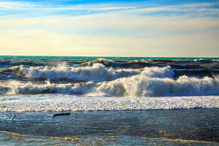 Storm at sea. Big gray waves and blue water. Beautiful horizon of the Black Sea in sunshine. Natural...