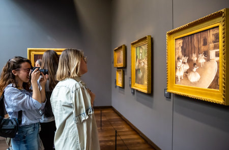 Paris, France - April 20, 2019: Visitors in museum Orsay. People looking at Ballet Rehearsal on Stage by impressionist Degas.のeditorial素材