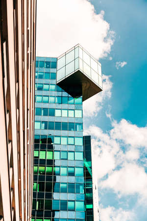 Reflection of cloudy sky in glass facade of modern building. Skylineの写真素材