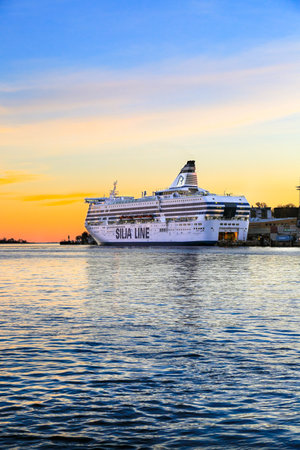 Helsinki, Finland - November 7, 2017: Scenic view of embankment, Gulf of Finland. Modern ferry boat "Silja Line" moored at pier in blue water Baltic sea.のeditorial素材