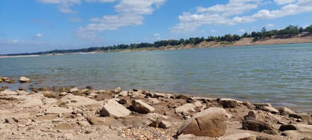 Panoramic view of a rocky shore by the lake.