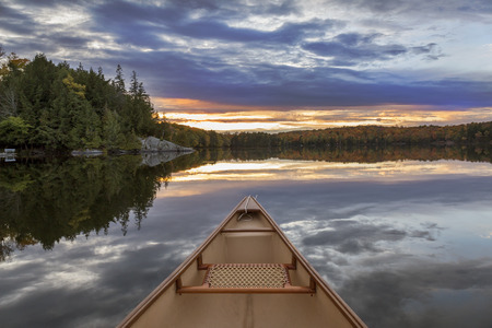 Canoe bow at sunset on an autumn lake in Ontario, Canadaの写真素材