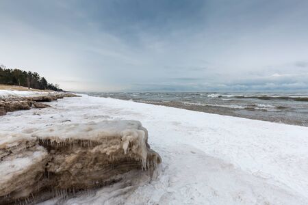 Snow and ice begin to build up along a Lake Huron shoreline in December - Grand Bend, Ontario, Canadaの写真素材