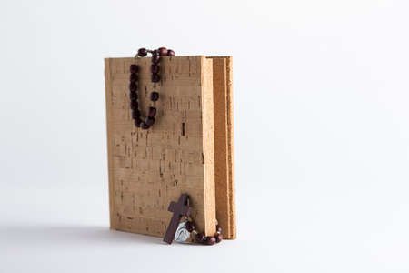Rosary beads necklace on blank cork book