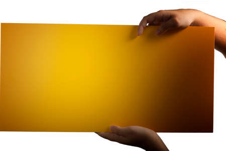A light yellow orange plywood square blank sign supported by young hands on light backgroundの写真素材