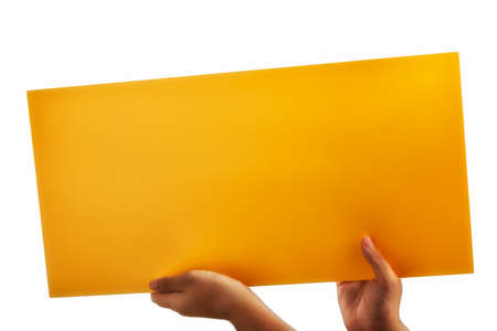 A light yellow orange plywood square blank sign supported by young hands on light backgroundの写真素材