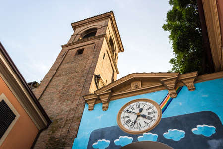 Steady works painted on the wall of the houses in the medieval small village of Dozza near Bologna in Emilia Romagna, Italy. Old clock in the middle.の写真素材