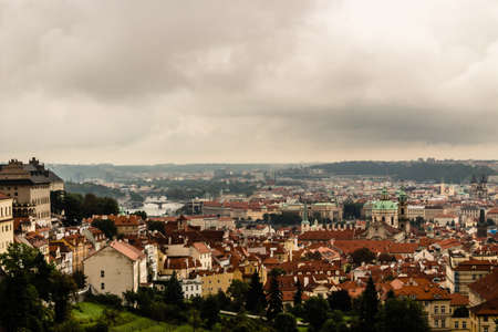 Gloomy day of rain and fog over the red roofs of Prague in the Czech Republic in Central Europe.の写真素材