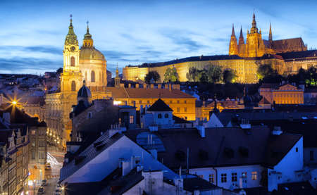 Night view of attractions in  Prague: St. Nicholas baroque church, Hradcany, the castle and St. Vitus Cathedral. Light traffics frames the buildings drawing regular linesのeditorial素材