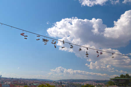 Scenic view of shoes hanging over the Vltava river and the historical center of Prague: houses, buildings and the characteristic and picturesque red rooftops and multi-coloured walls.の写真素材
